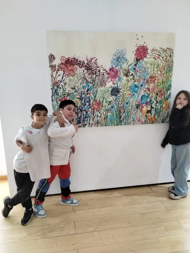 Estudiantes junto a una obra de Estela Pacheco